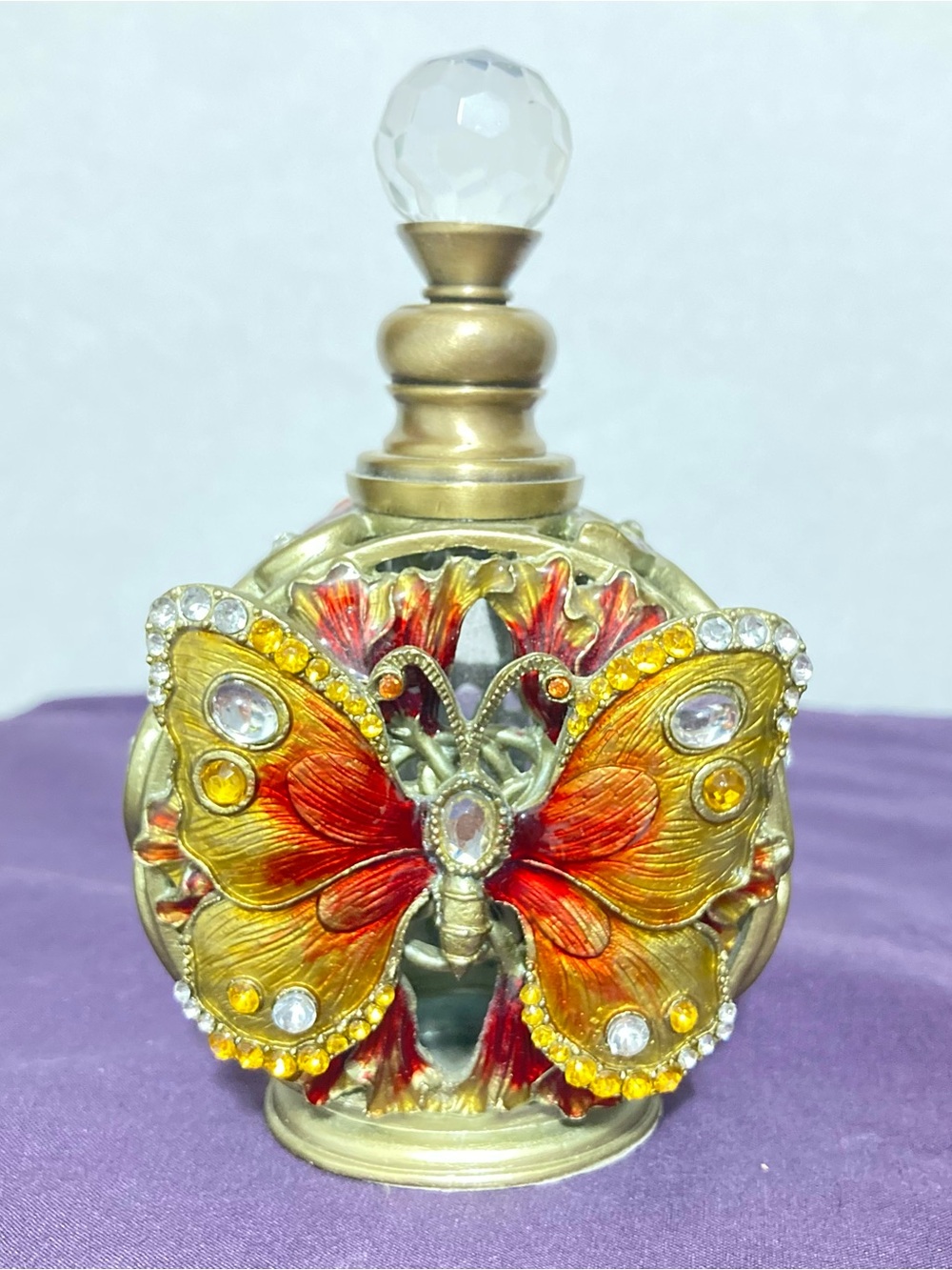 Decorative Butterfly Perfume Bottle - Gold and Red bedazzled metal frame.
